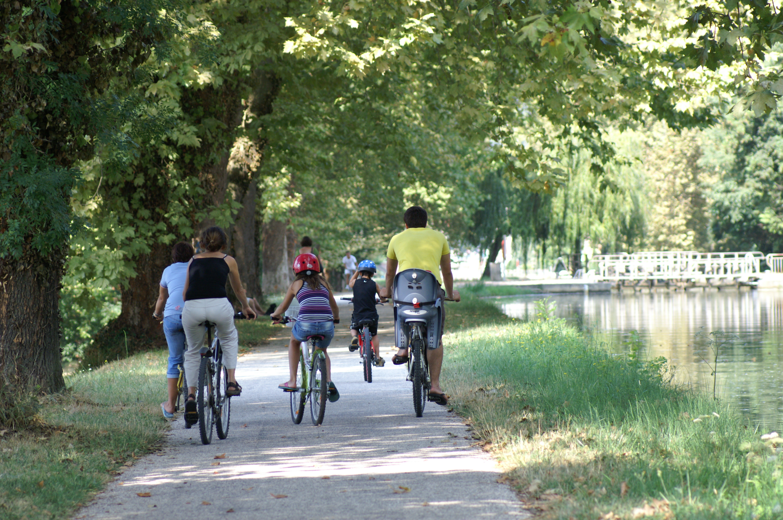 Photo d'une famille faisant du vélo le long du canal latéral - Crédit Photo : ADT82